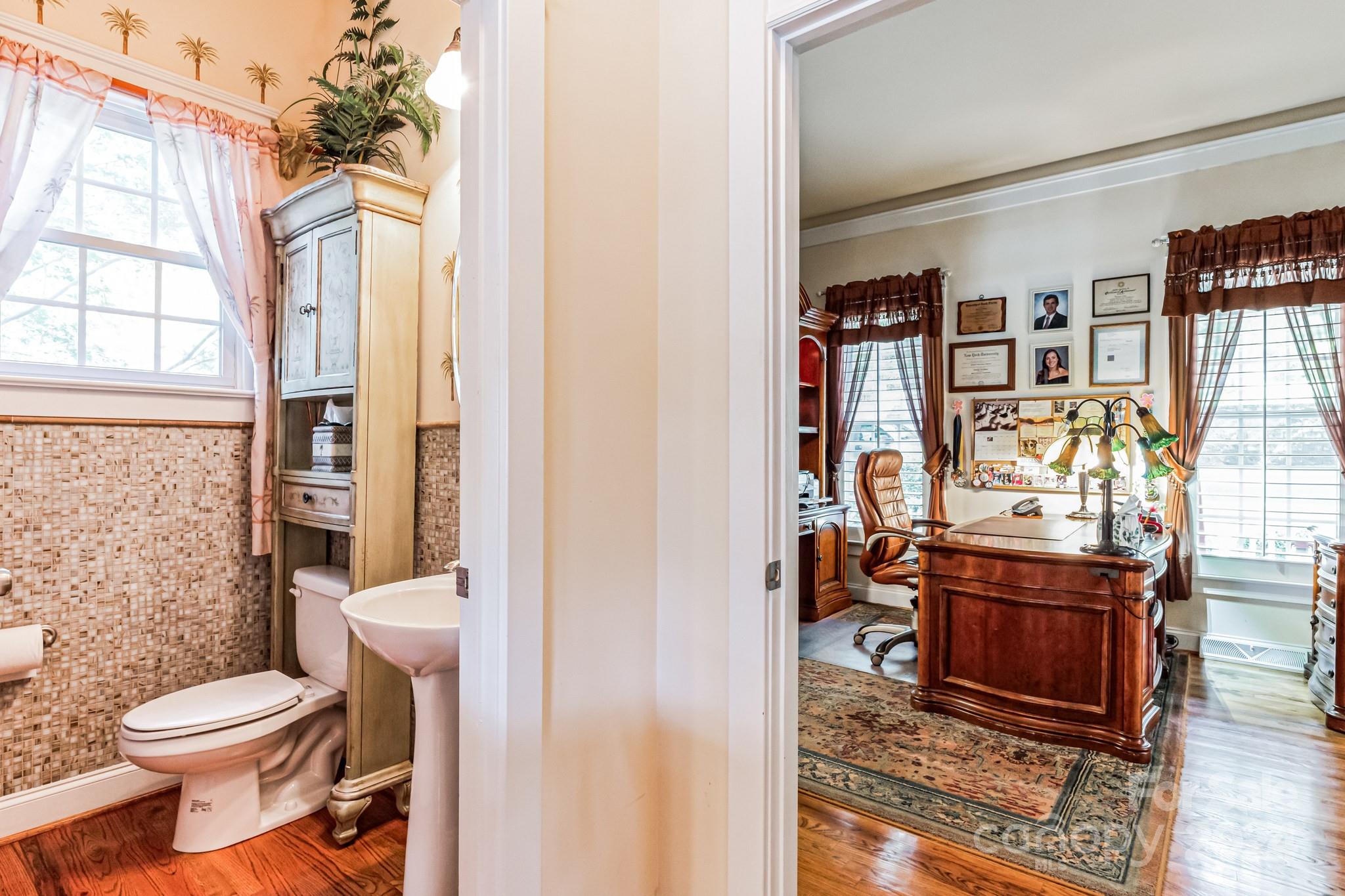 936 Rocky Point Lane Tega Cay, SC 29708 - Photo 41 of 48 a bathroom with a toilet a sink and a window