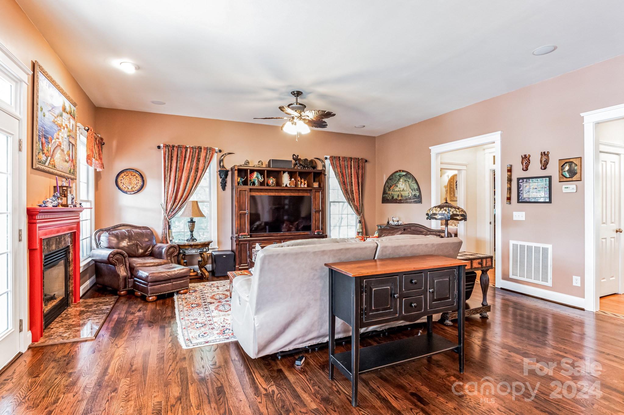 936 Rocky Point Lane Tega Cay, SC 29708 - Photo 42 of 48 a view of a livingroom with furniture a ceiling fan and wooden floor