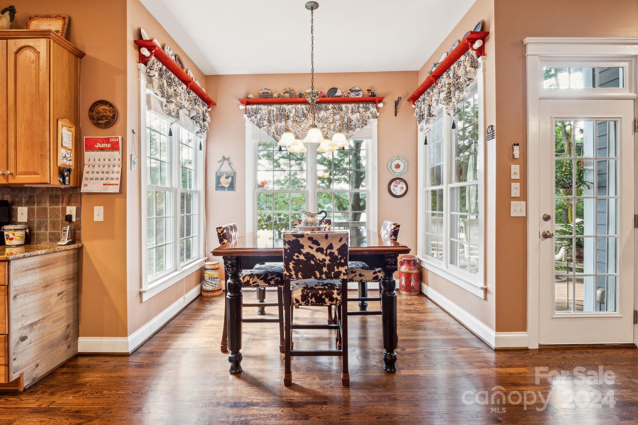 936 Rocky Point Lane Tega Cay, SC 29708 - Photo 43 of 48 a view of a dining room with furniture window and wooden floor