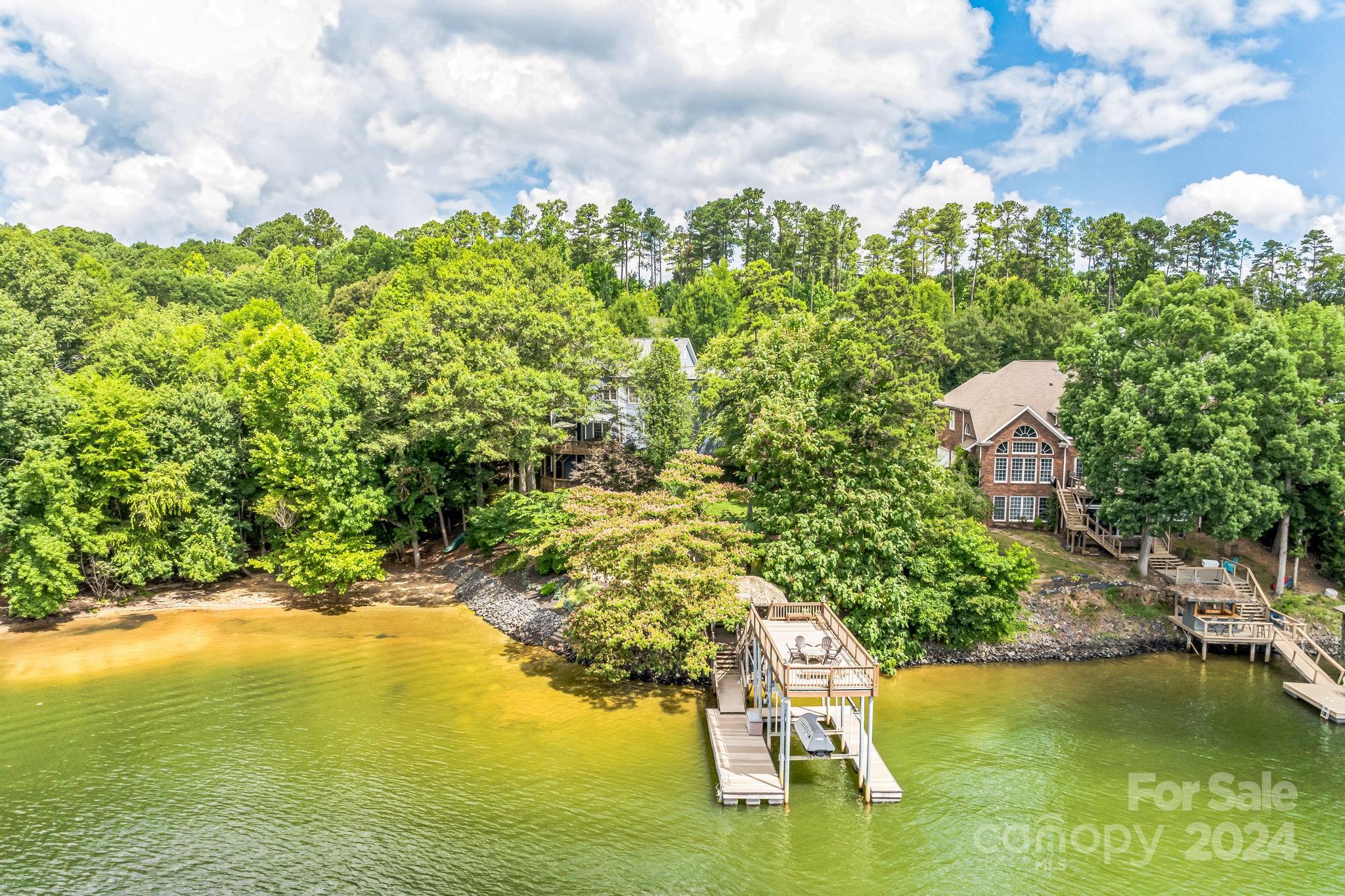 936 Rocky Point Lane Tega Cay, SC 29708 - Photo 6 of 48 a view of a lake with a building in the background