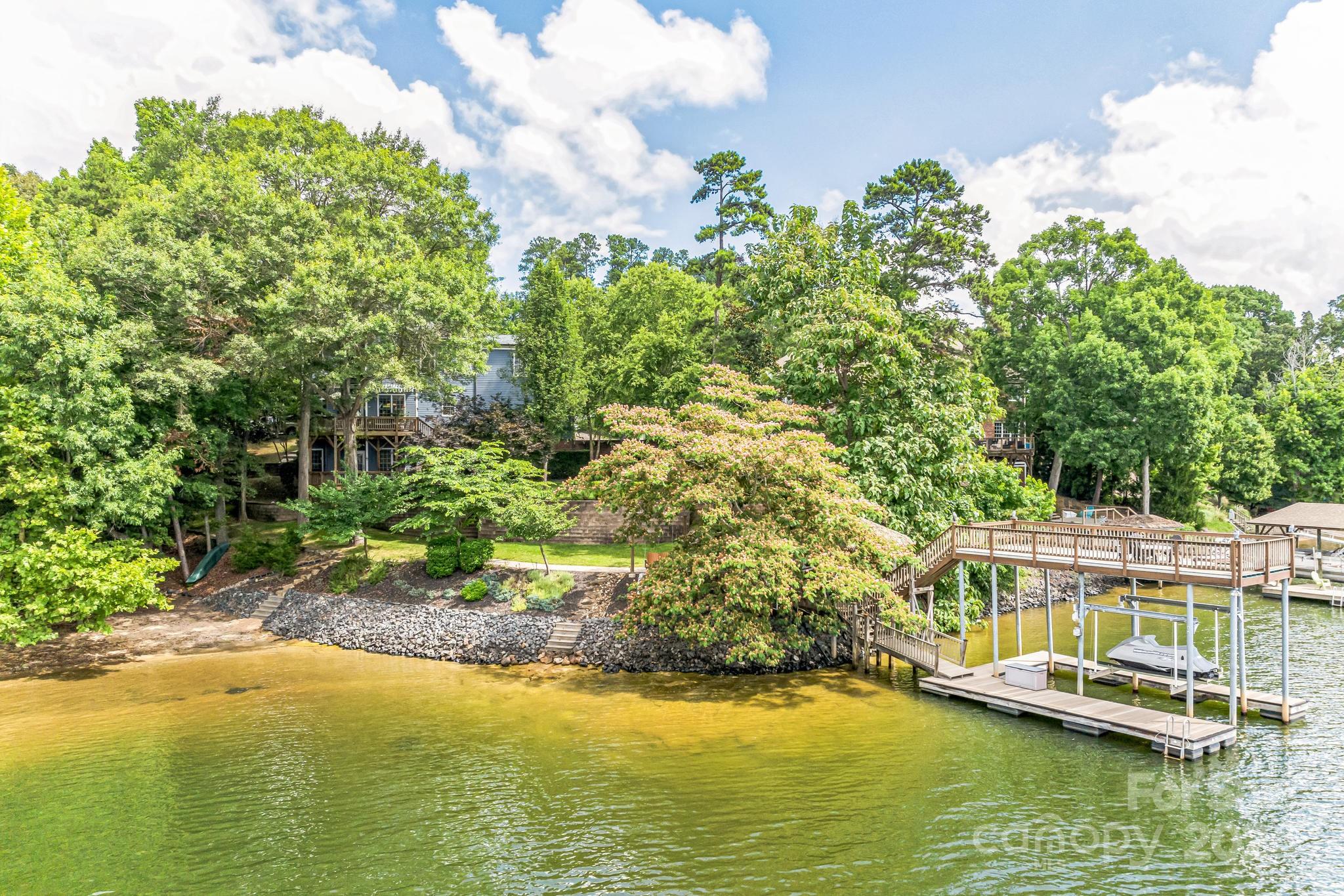 936 Rocky Point Lane Tega Cay, SC 29708 - Photo 7 of 48 a view of a swimming pool with a yard