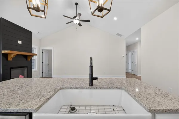 a kitchen with kitchen island a counter top space a sink and stainless steel appliances