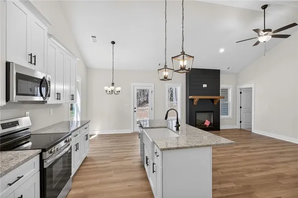 a kitchen with kitchen island a sink stainless steel appliances and cabinets