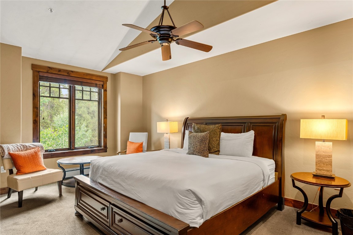 600 Columbine Road, Unit 5310 Breckenridge, CO 80424 - Photo 13 of 38 a bedroom with a bed and a chandelier