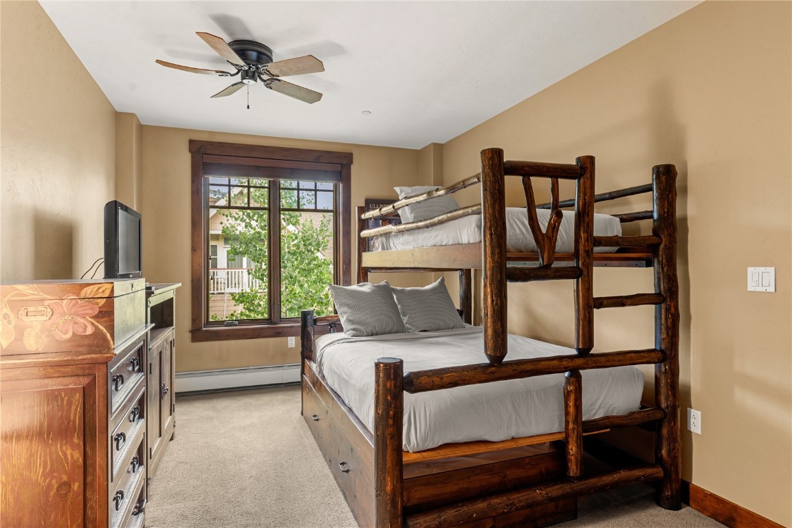 600 Columbine Road, Unit 5310 Breckenridge, CO 80424 - Photo 18 of 38 a bedroom with a bed a flat screen tv and a large window with the outer view