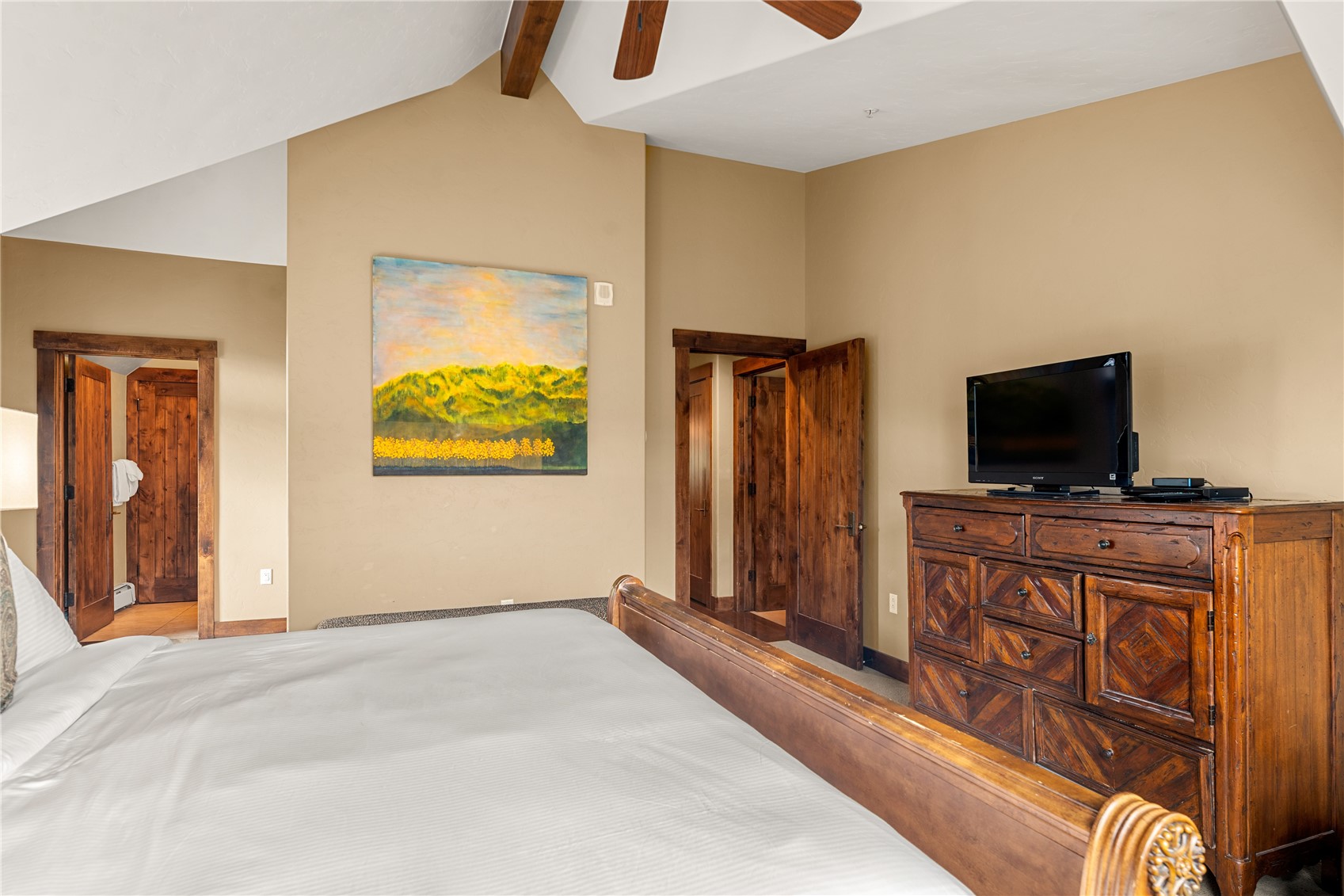 600 Columbine Road, Unit 5310 Breckenridge, CO 80424 - Photo 21 of 38 a bedroom with a bed and a flat screen tv