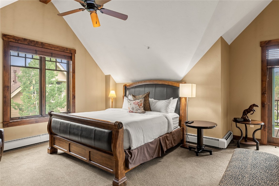 600 Columbine Road, Unit 5310 Breckenridge, CO 80424 - Photo 21 of 38 a bedroom with a bed a chandelier and a dresser next to a window