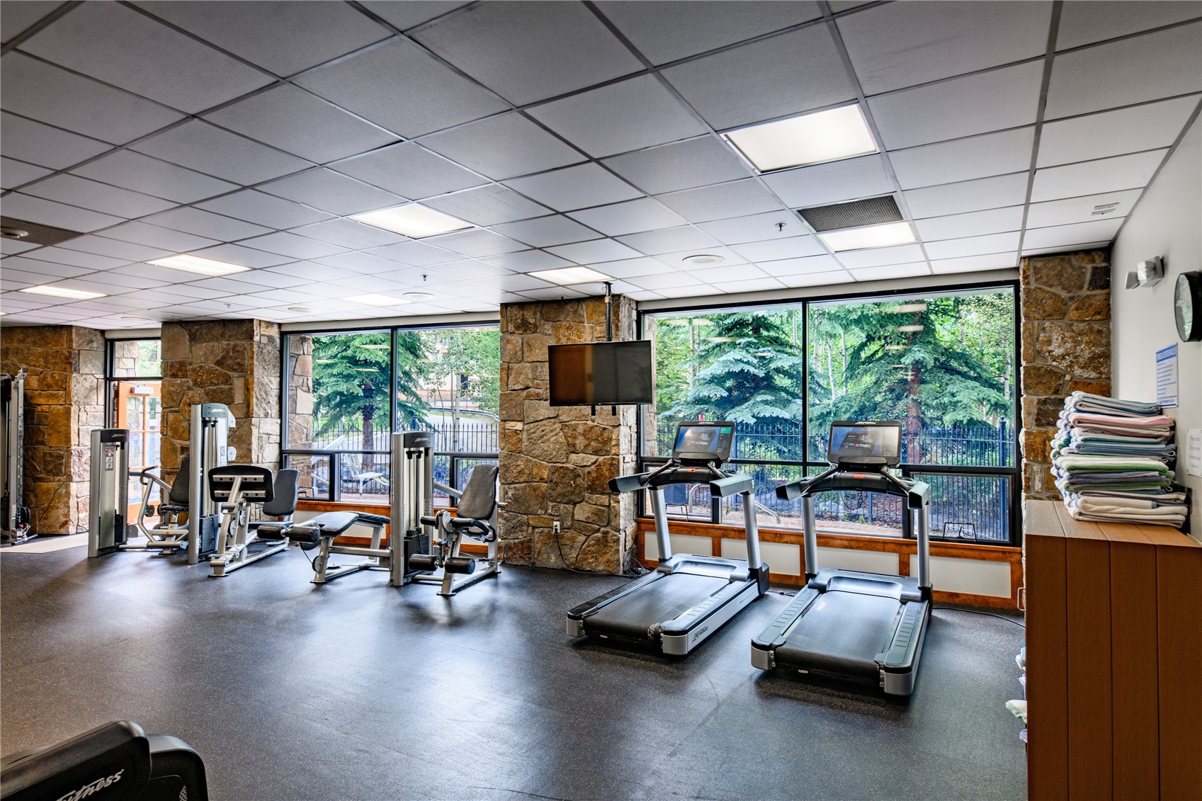 600 Columbine Road, Unit 5310 Breckenridge, CO 80424 - Photo 31 of 38 a room with gym equipment and large windows