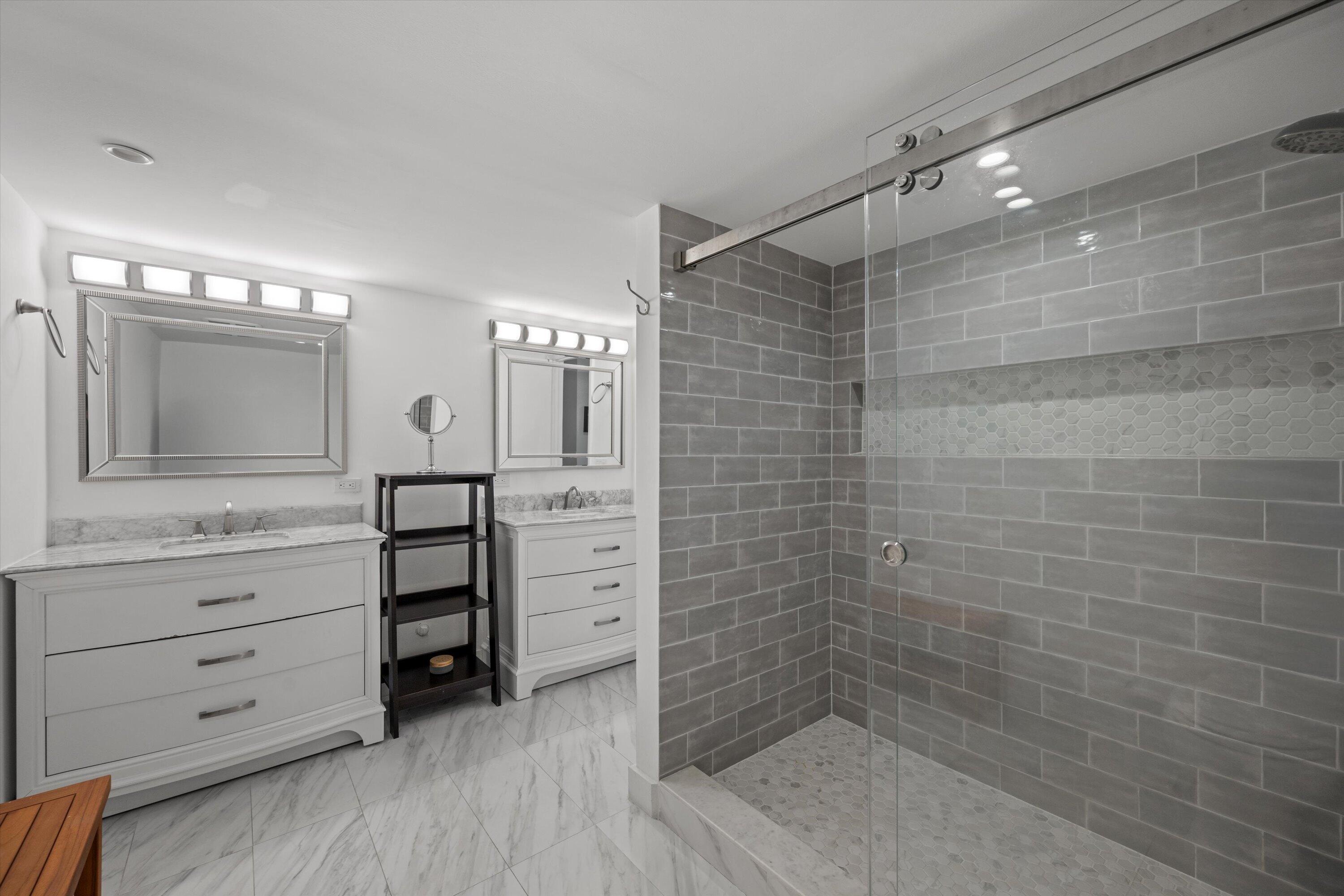13400 Polo Road West, Unit 203 Wellington, FL 33414 - Photo 15 of 26 a bathroom with a shower vanity and a mirror