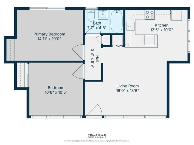 a small yard with a white table and chair and white walls