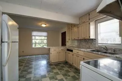 a kitchen with stainless steel appliances granite countertop a sink stove and cabinets