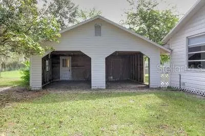 a view of a house with a yard and garage