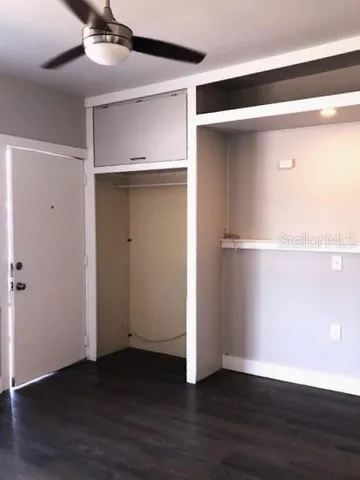 a view of an empty room with wooden floor