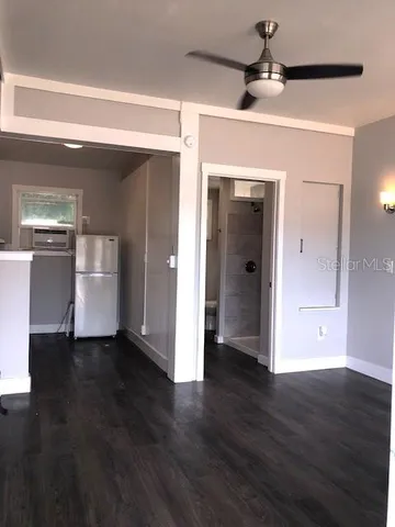 a kitchen with a sink a refrigerator and window