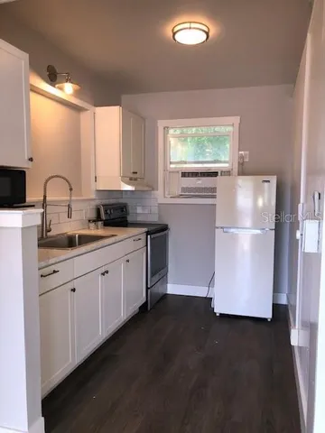 a bathroom with a toilet sink vanity and mirror