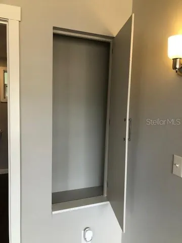 a view of a storage and utility room with washer and dryer