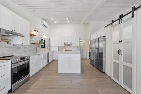 a kitchen with stainless steel appliances a refrigerator sink and stove