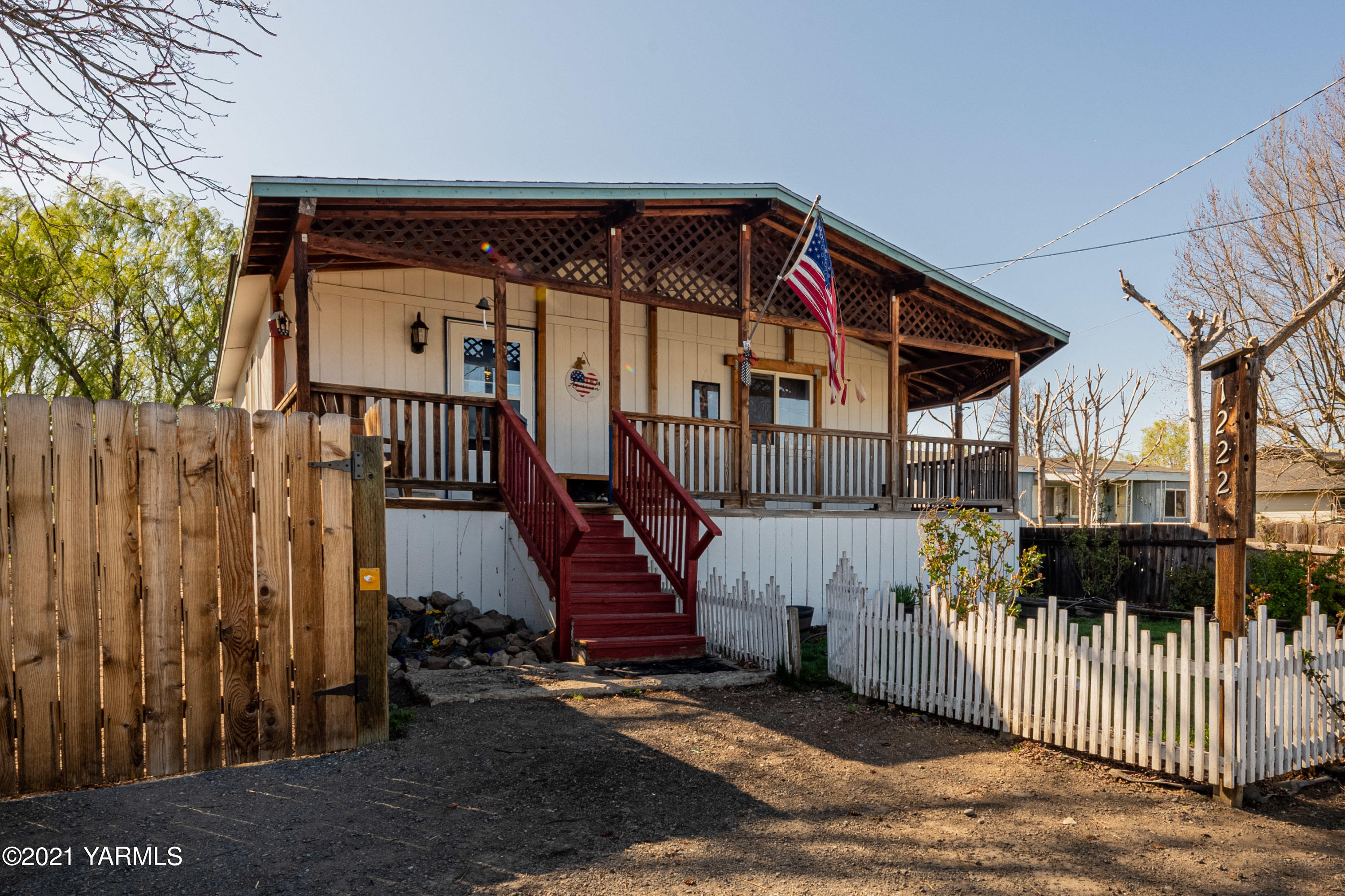 1222 Almo Road Yakima, WA 98901 - Photo 1 of 23 a view of a house with wooden fence and a porch
