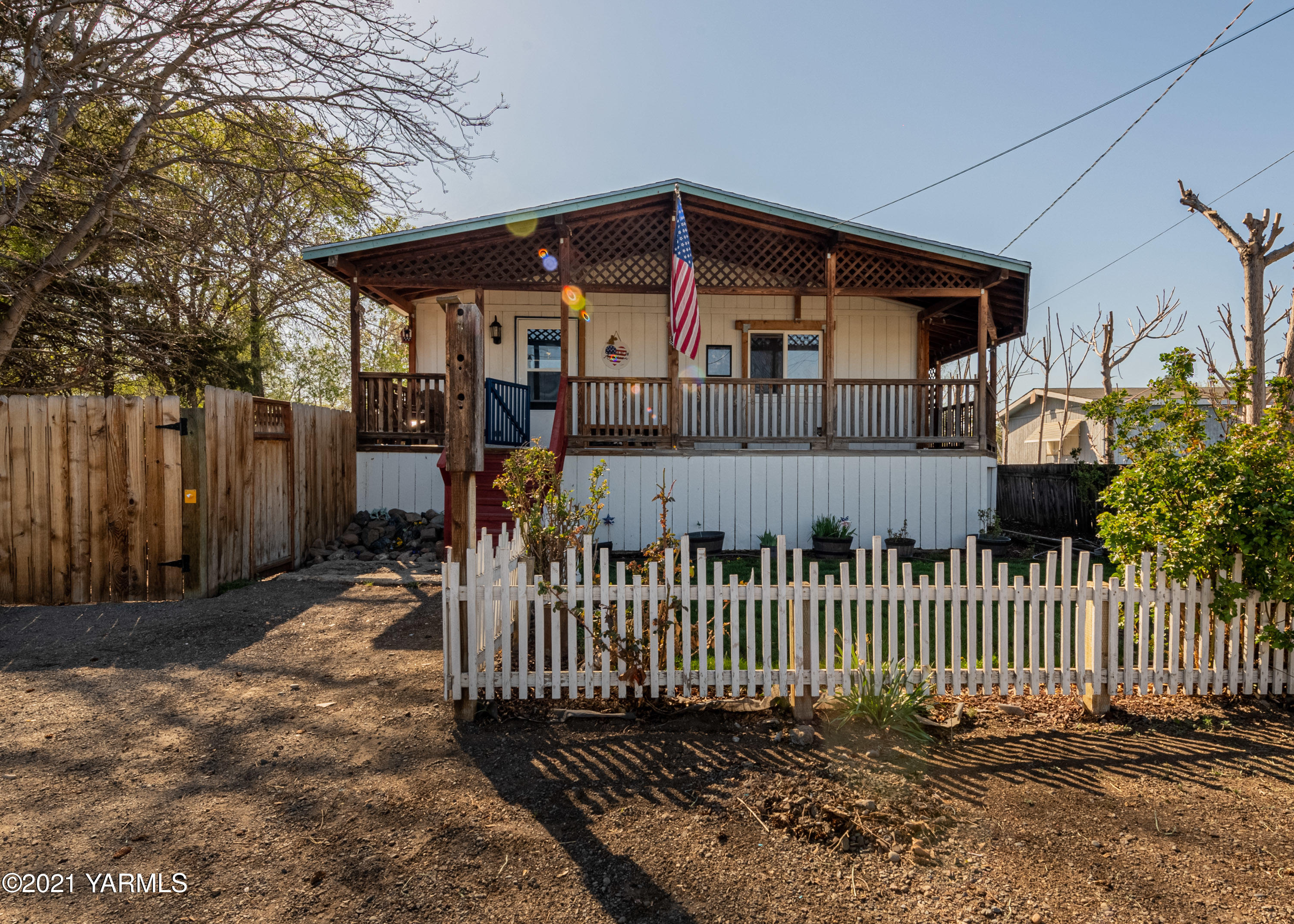 1222 Almo Road Yakima, WA 98901 - Photo 2 of 23 a view of a small yard with wooden fence