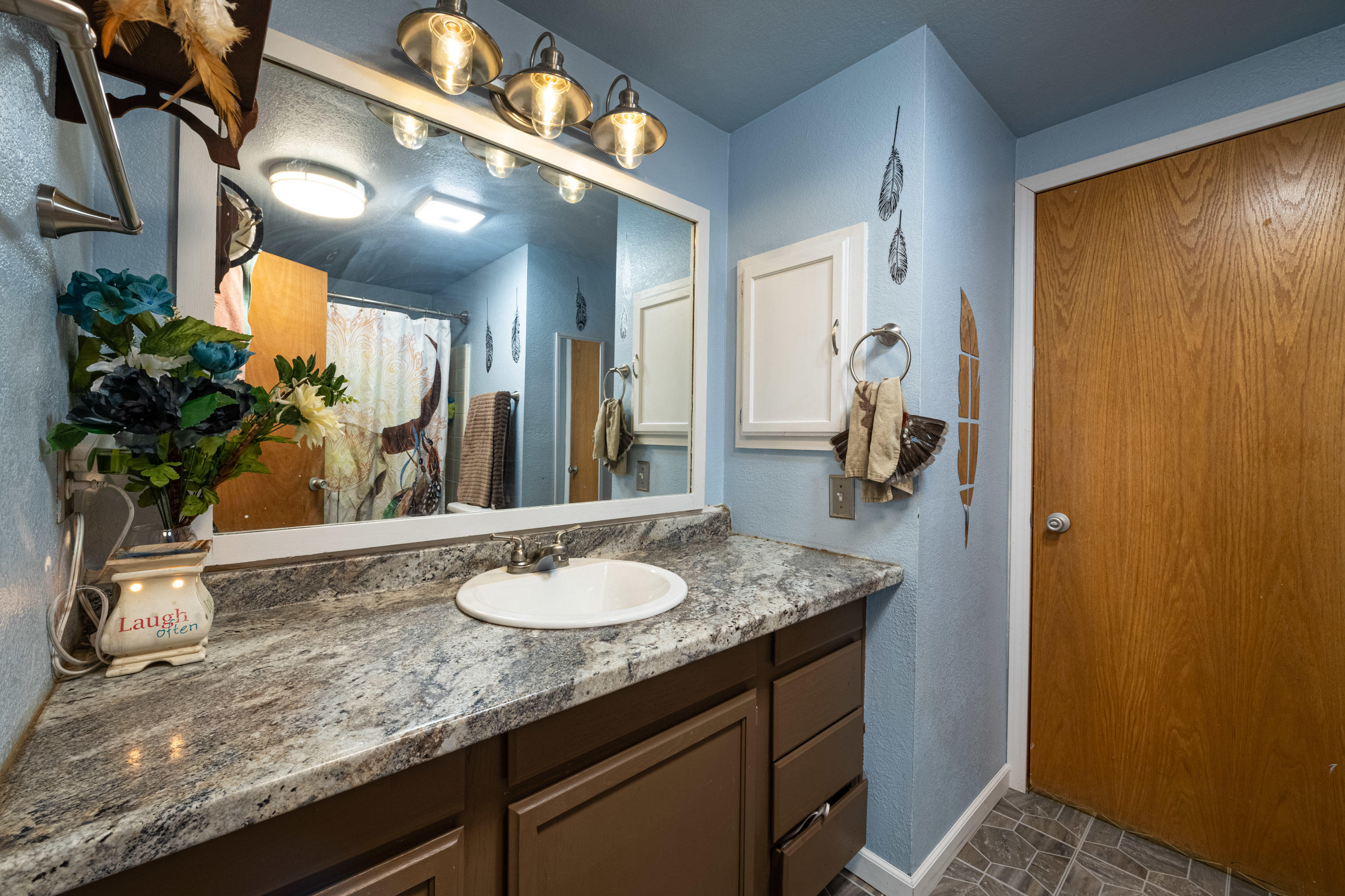 1222 Almo Road Yakima, WA 98901 - Photo 16 of 23 a bathroom with a granite countertop sink and a mirror