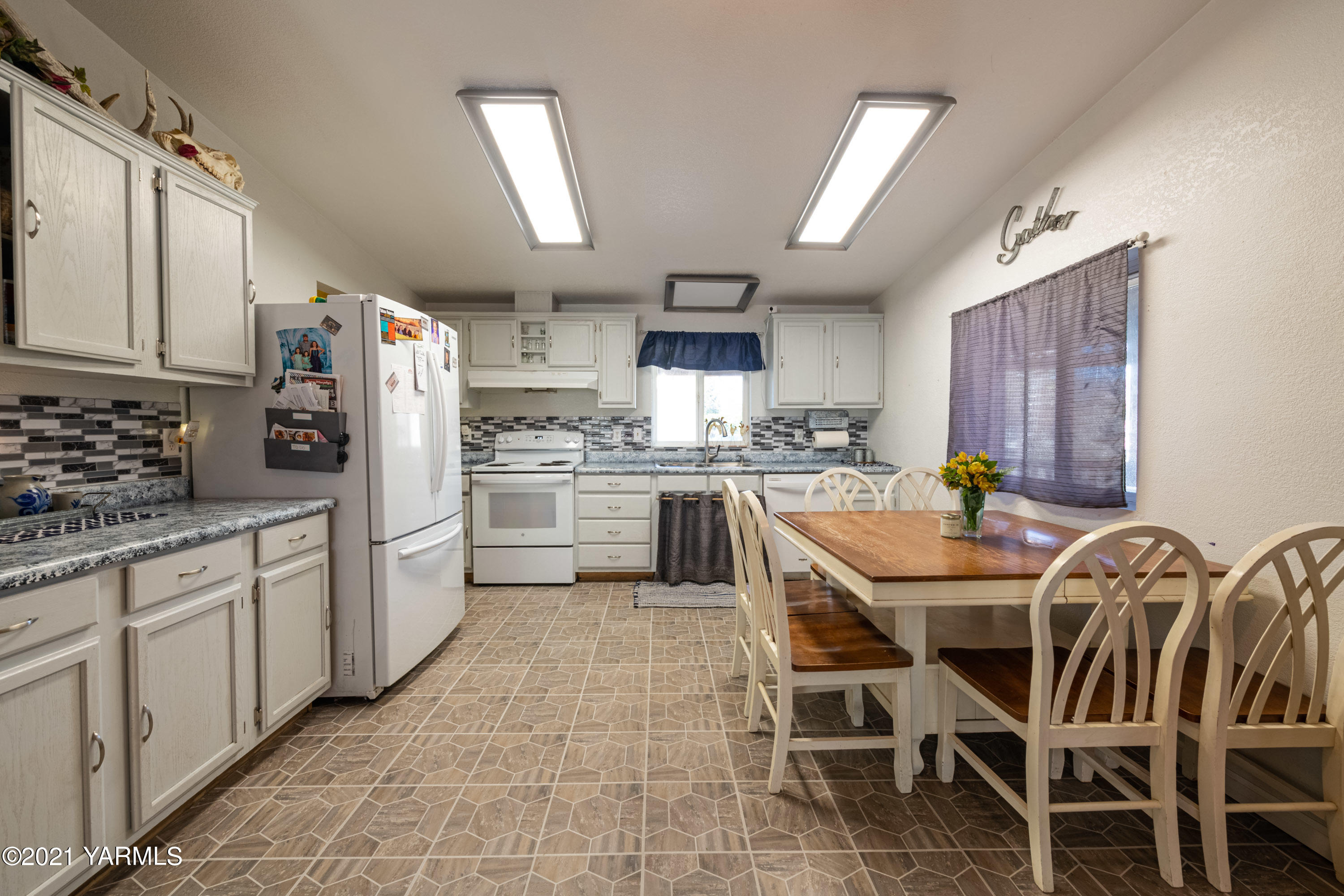 1222 Almo Road Yakima, WA 98901 - Photo 8 of 23 a kitchen with stainless steel appliances granite countertop a table chairs sink refrigerator and cabinets
