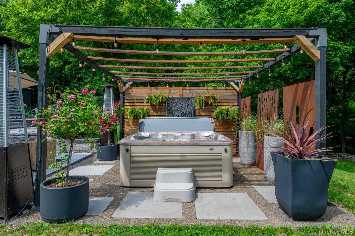 13 Jacks Pond Road Newburgh, NY 12550 - Photo 33 of 44 Outdoor spa area featuring a dark metal and wood pergola.