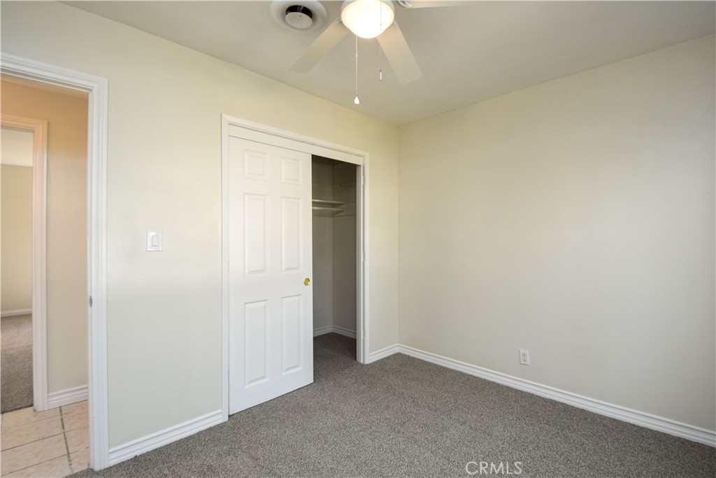 41431 Vicky Lane Hemet, CA 92544 - Photo 17 of 28 an empty room with a ceiling fan and a bathroom