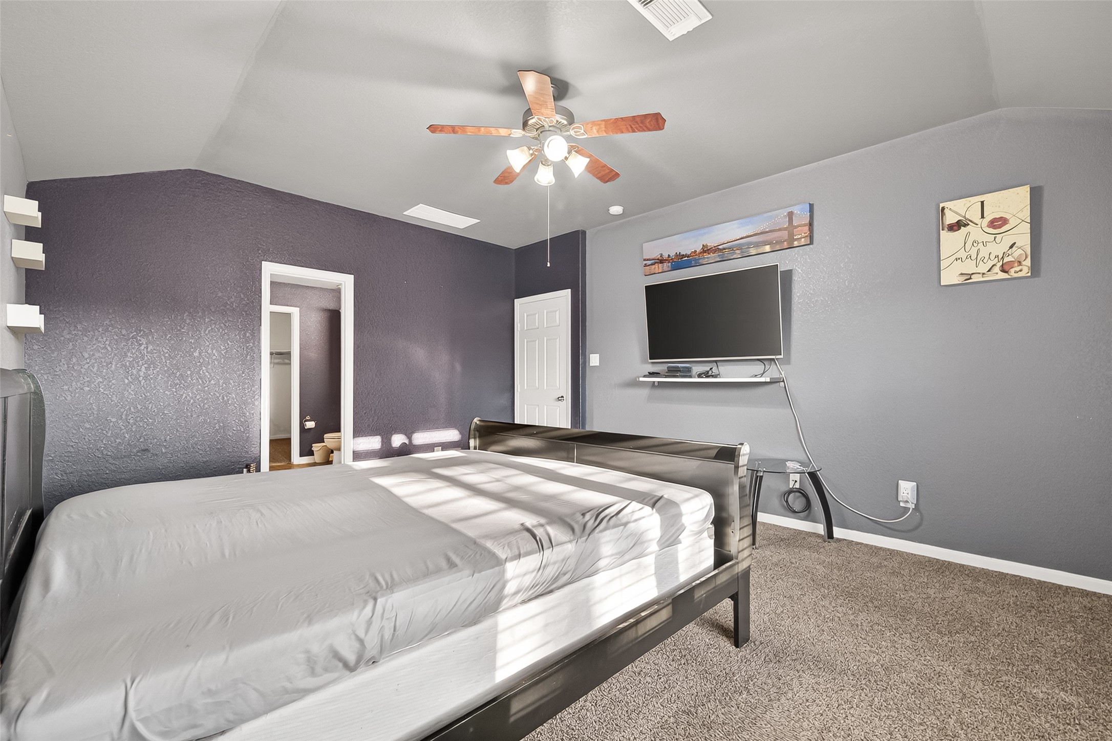 16715 Mackenzie Mesa Drive Spring, TX 77379 - Photo 36 of 50 a bedroom with a large bed and a flat tv screen on dresser