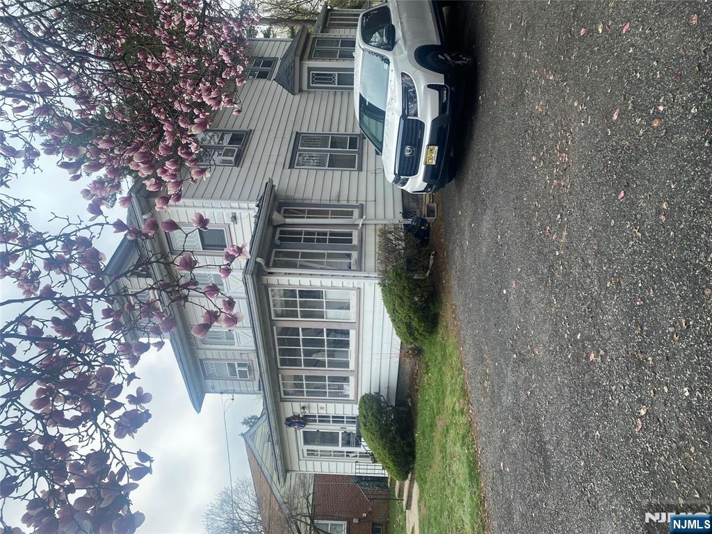 30 North Demarest Avenue Bergenfield, NJ 07621 - Photo 2 of 12 a view of a house with a garden and trees
