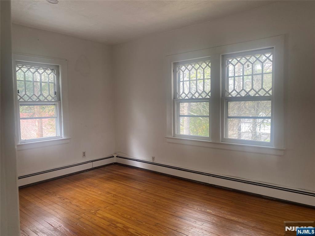 30 North Demarest Avenue Bergenfield, NJ 07621 - Photo 6 of 12 an empty room with wooden floor and windows