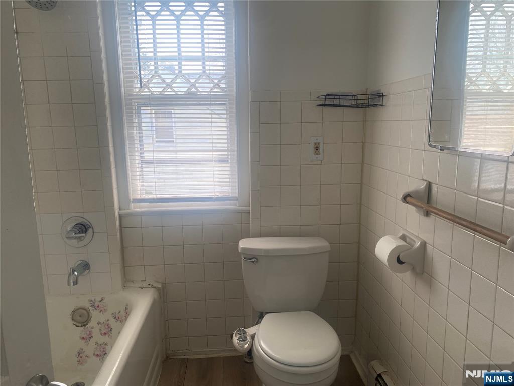 30 North Demarest Avenue Bergenfield, NJ 07621 - Photo 9 of 12 a white toilet sitting next to a bath tub a sink