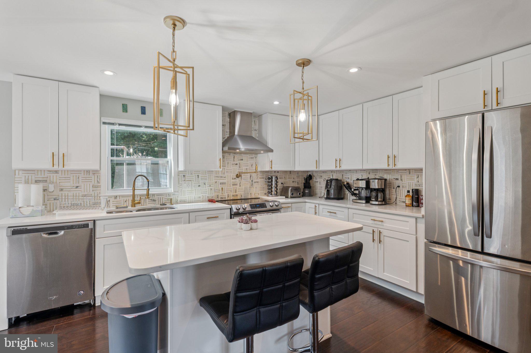 7310 Torran Rocks Way Gaithersburg, MD 20879 - Photo 1 of 26 a kitchen with a sink a stove a refrigerator and white cabinets