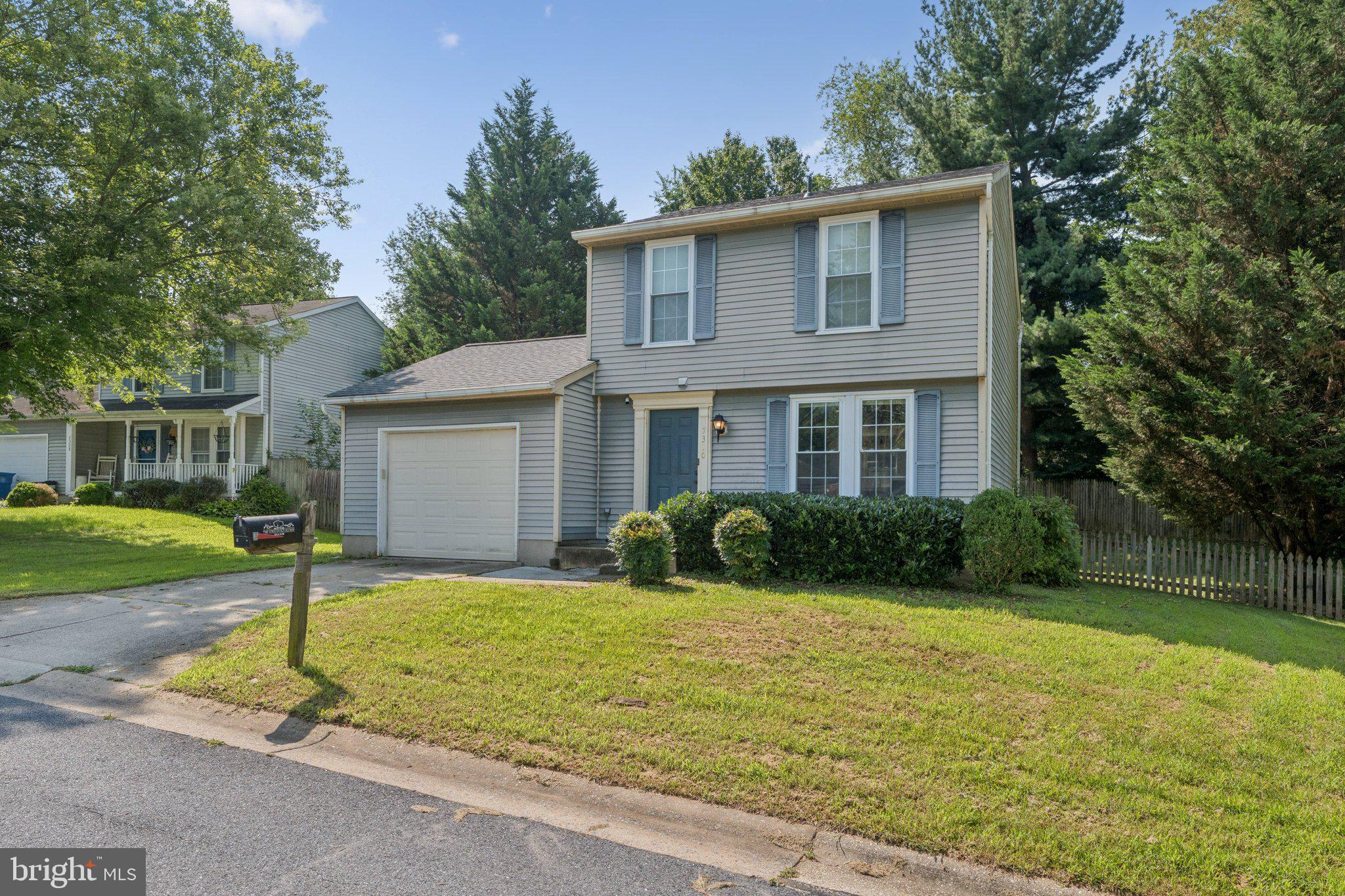 7310 Torran Rocks Way Gaithersburg, MD 20879 - Photo 2 of 26 a front view of a house with yard and green space