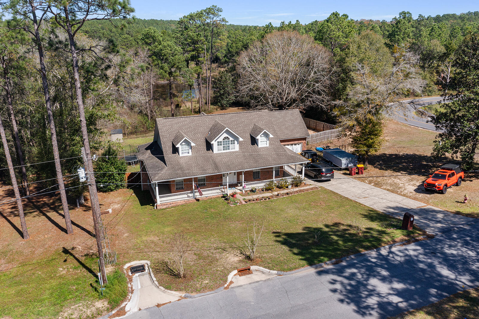 an aerial view of a house with a garden and swimming pool