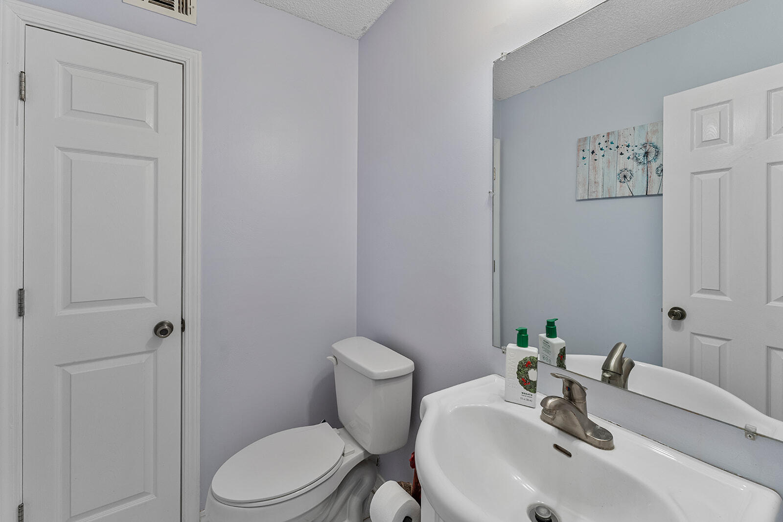 132 Wedgewood Lane Crestview, FL 32536 - Photo 28 of 67 a bathroom with a sink a toilet and a mirror