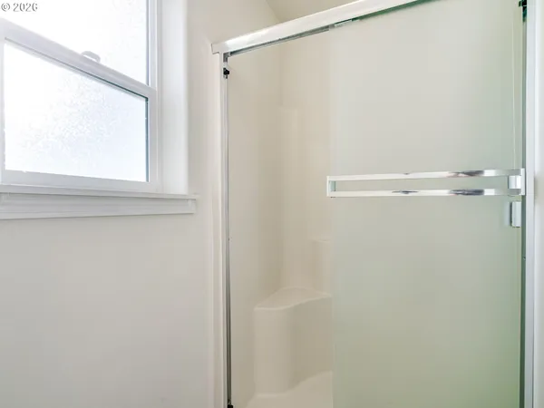 a bathroom with a glass shower door