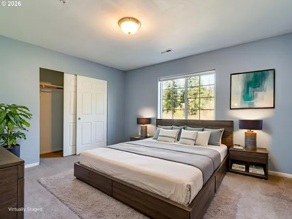 a bedroom with a bed and a potted plant