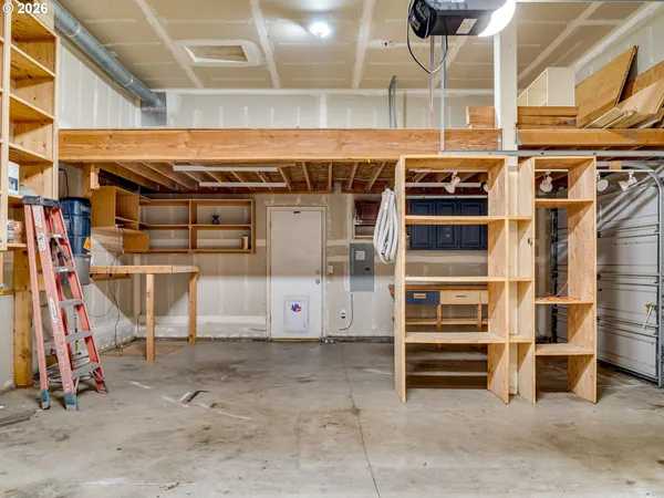 a view of an empty room with wooden shelves