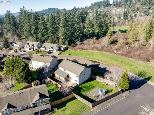 an aerial view of a house with a garden and lake view