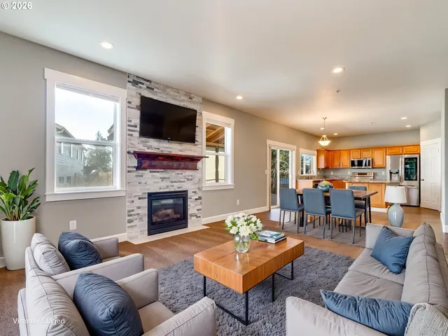 a living room with furniture fireplace and window