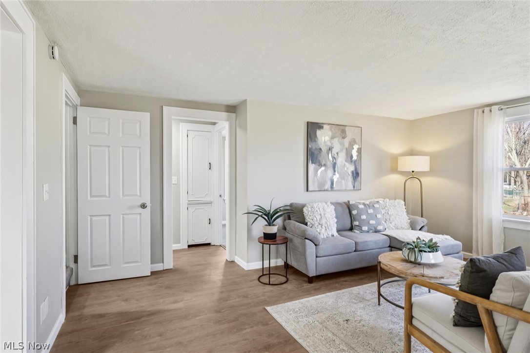 Living room with wood finished floors and a textured ceiling