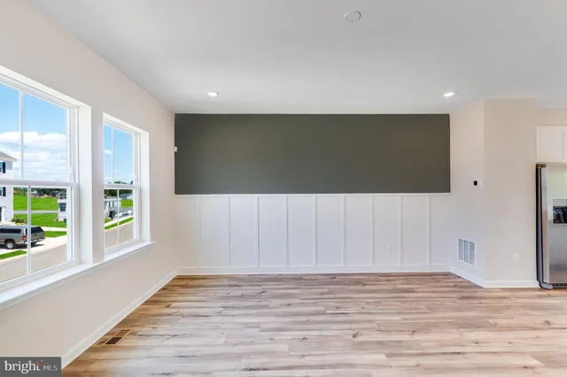 a view of a kitchen with furniture and wooden floor