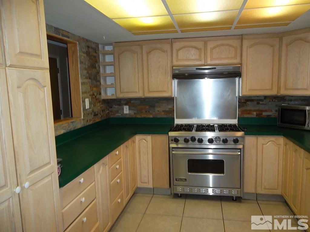 1575 Carlin Street Reno, NV 89503 - Photo 11 of 17 a kitchen with a stove and a refrigerator