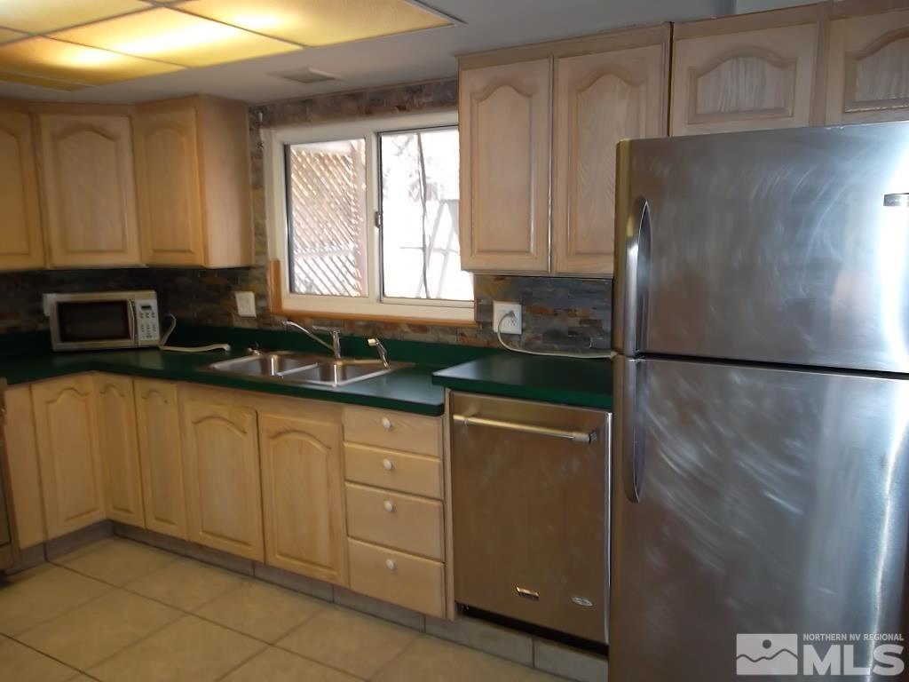 1575 Carlin Street Reno, NV 89503 - Photo 12 of 17 a kitchen with a refrigerator and a sink