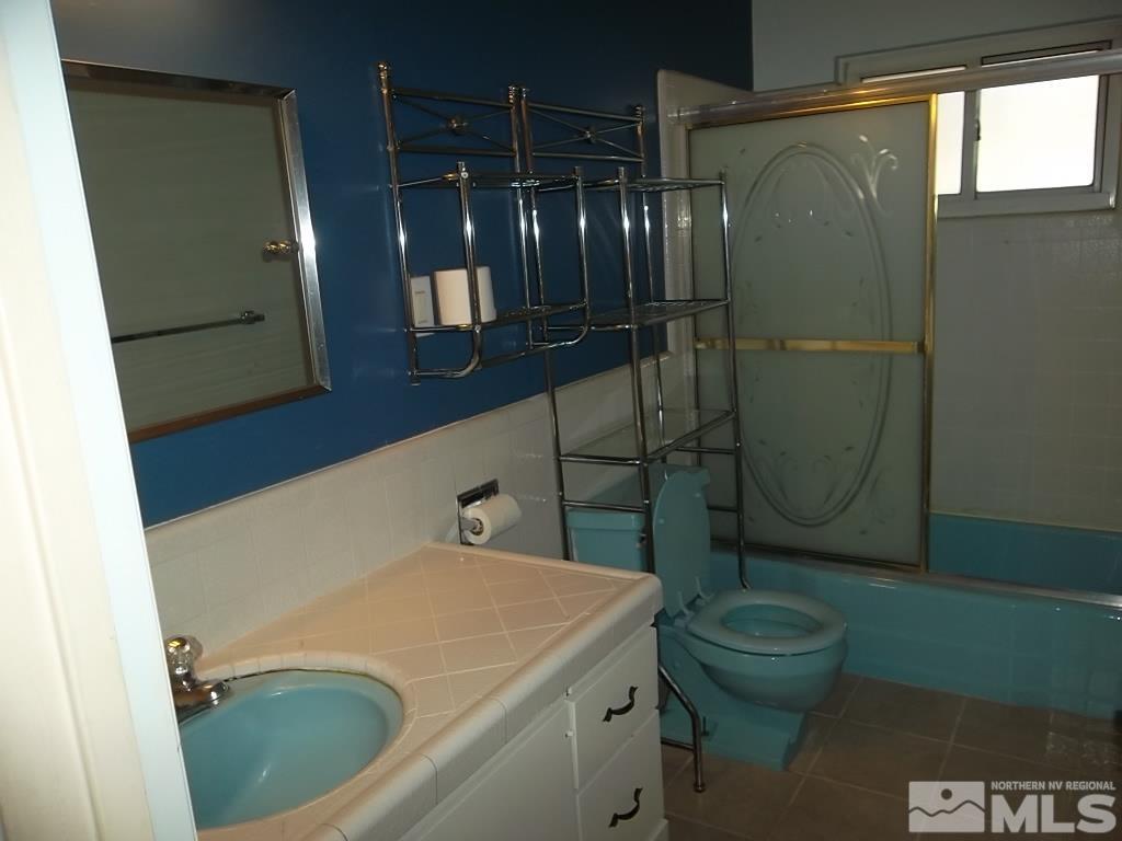 1575 Carlin Street Reno, NV 89503 - Photo 14 of 17 a bathroom with a sink a toilet and shower