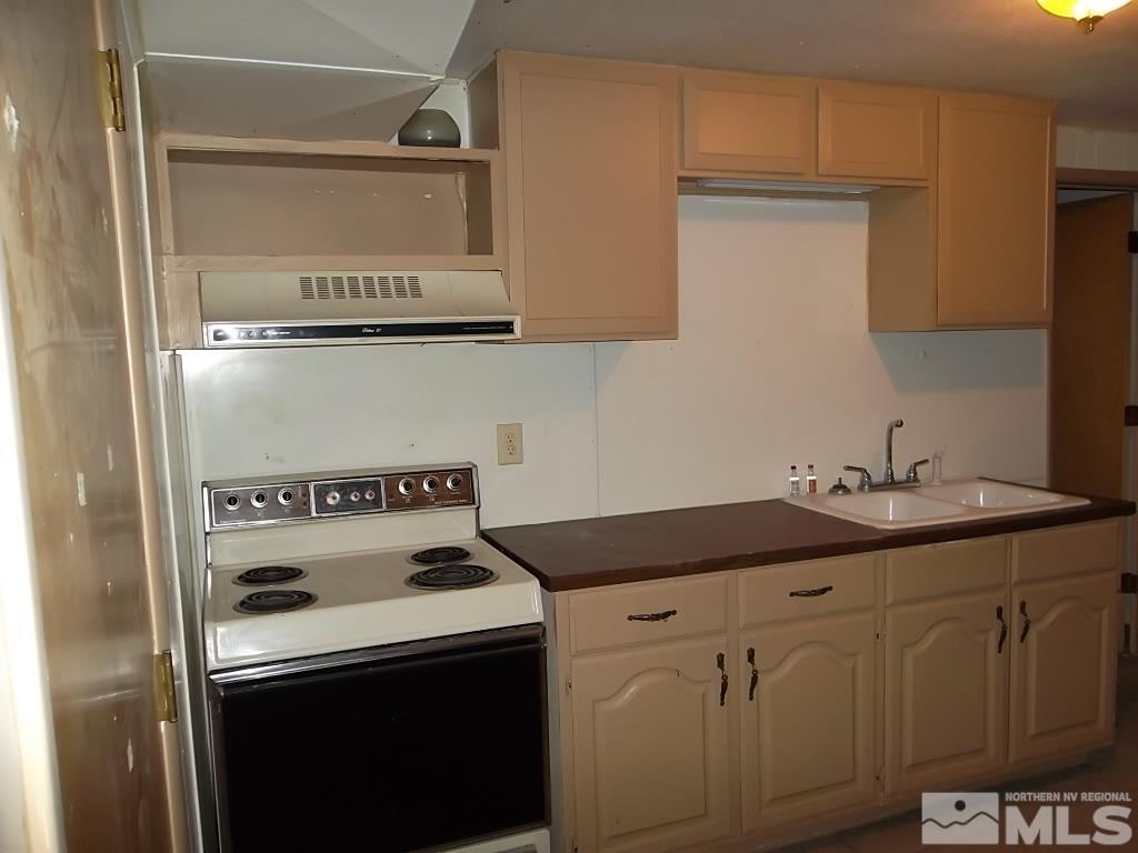 1575 Carlin Street Reno, NV 89503 - Photo 5 of 17 a kitchen with granite countertop a sink and a stove