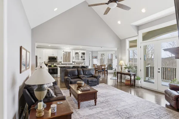 a living room with furniture and a chandelier