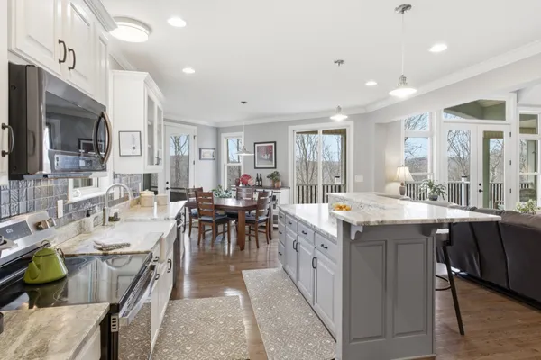a large kitchen with lots of counter top space and living room