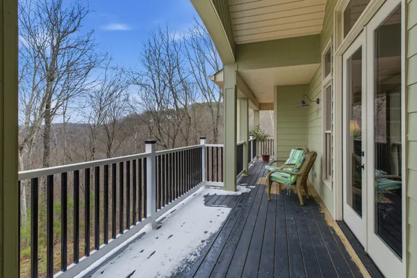 a view of a balcony with couch and wooden floor