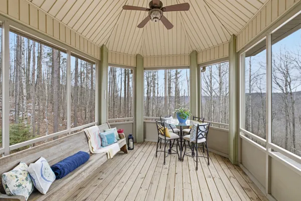 a living room with furniture and floor to ceiling windows